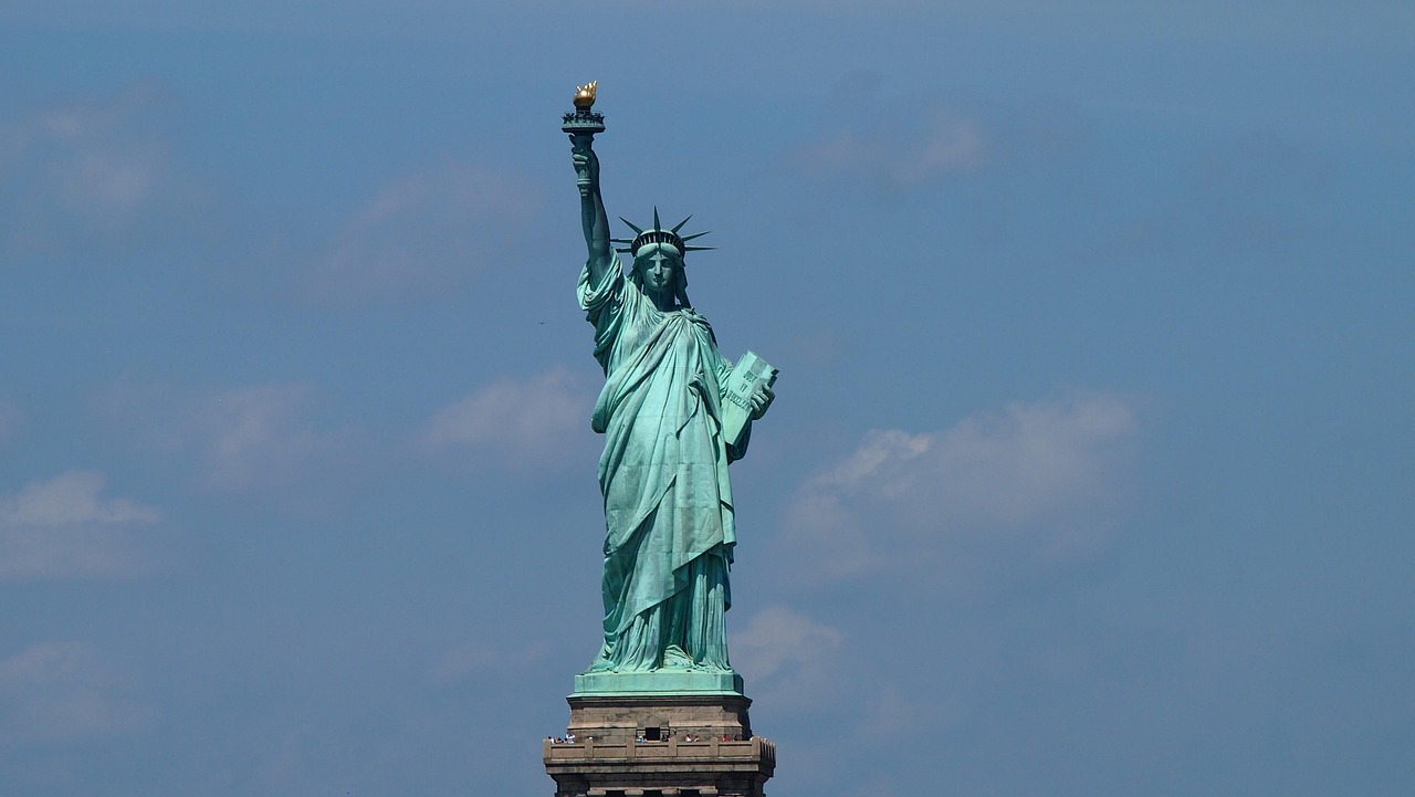 Manhattan’s glittering skyline meets the historic silhouette of the Statue of Liberty — a quintessential scene among must-visit places in the USA Aerial view of Manhattan skyline with Statue of Liberty in foreground