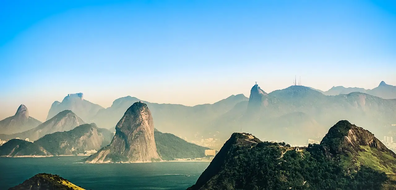 Iconic Christ the Redeemer statue overlooking Guanabara Bay and the Tijuca Forest in Rio de Janeiro, Brazil — a symbol of faith, architecture, and natural grandeur Aerial view of Christ the Redeemer statue overlooking Rio de Janeiro's coastline and lush mountains