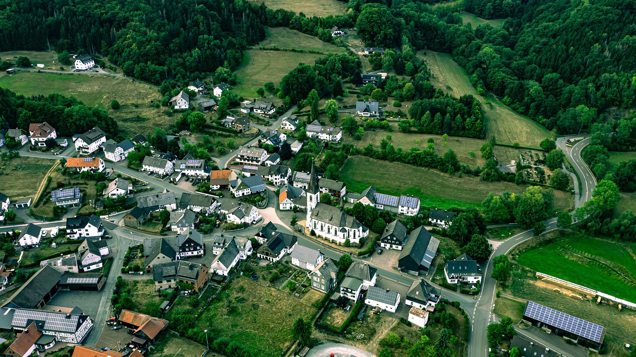 A sweeping aerial perspective showcasing Germany’s geographical and cultural variety — from the Alps to the North Sea coast, illustrating why these 15 must-visit places in Germany represent the nation’s full spectrum. Aerial view of Germany's diverse landscape: mountains, forests, rivers, and historic towns