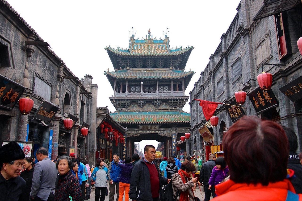 Warm sunset light bathes Pingyao Ancient City’s 600-year-old rammed-earth wall, dotted with traditional watchtowers and festive red lanterns Sunset over Pingyao’s ancient city wall with watchtowers and red lanterns glowing along the ramparts