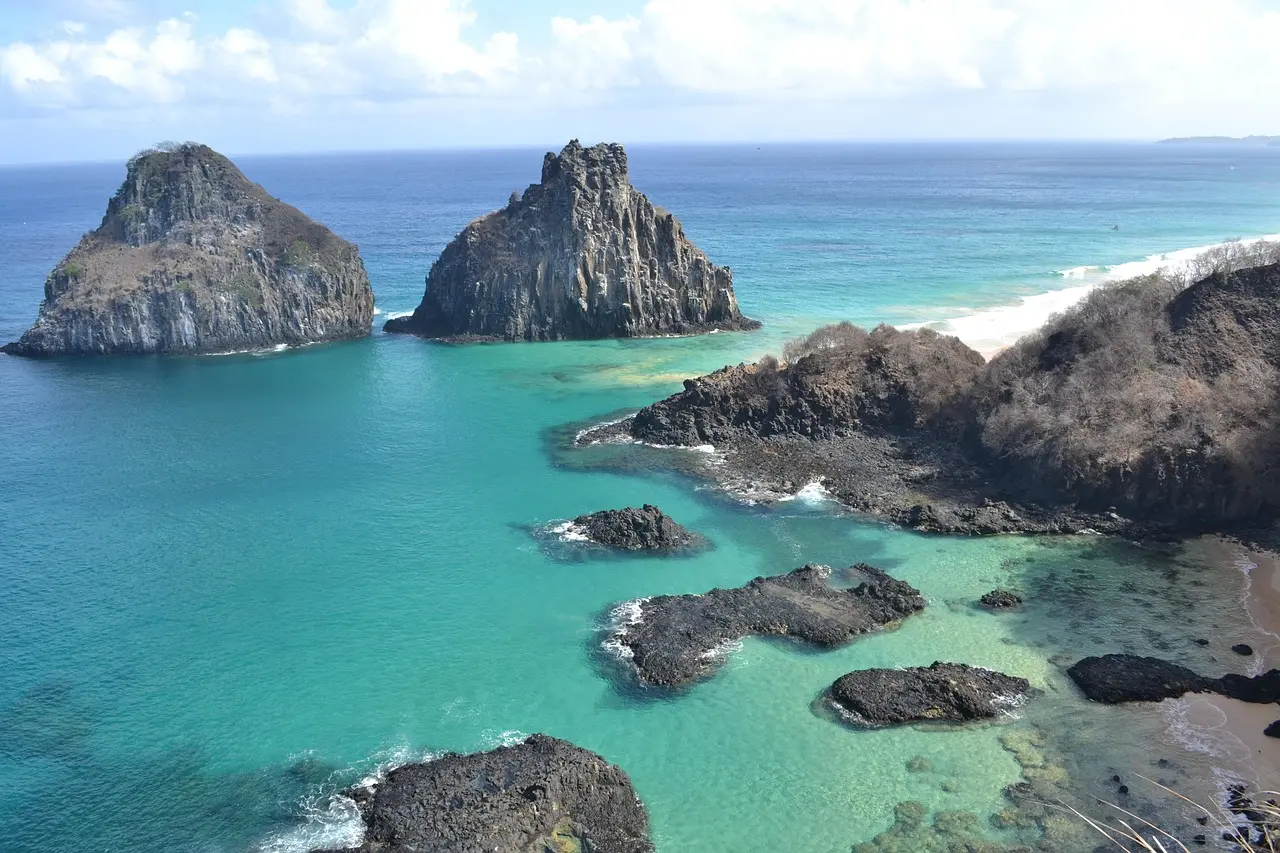 Crystal-clear turquoise waters lapping a secluded white-sand cove at Baía do Sancho — Fernando de Noronha’s crown-jewel beach and protected marine sanctuary in northeastern Brazil Turquoise waters and white-sand cove at Baía do Sancho, Fernando de Noronha
