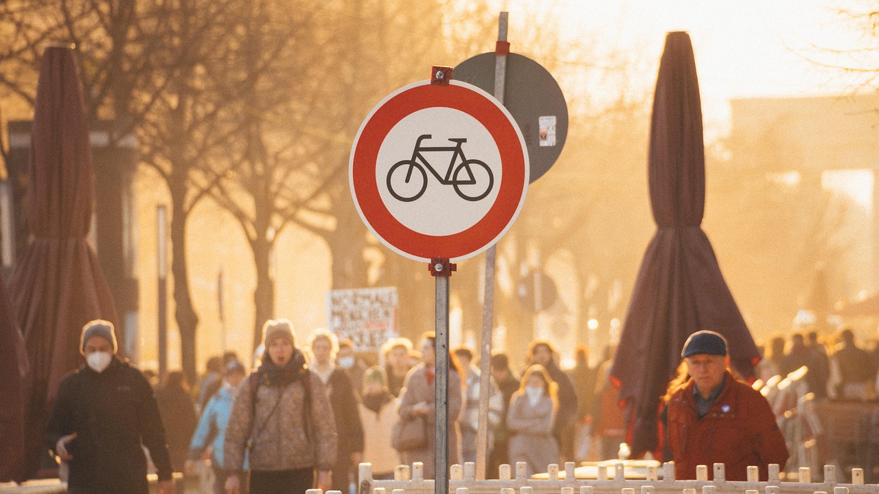 The majestic Brandenburg Gate glowing at sunset, framed by cobblestone streets and historic facades — an essential stop among the 15 must-visit places in Germany and a powerful emblem of resilience. Brandenburg Gate at golden hour with pedestrians and historic architecture in background