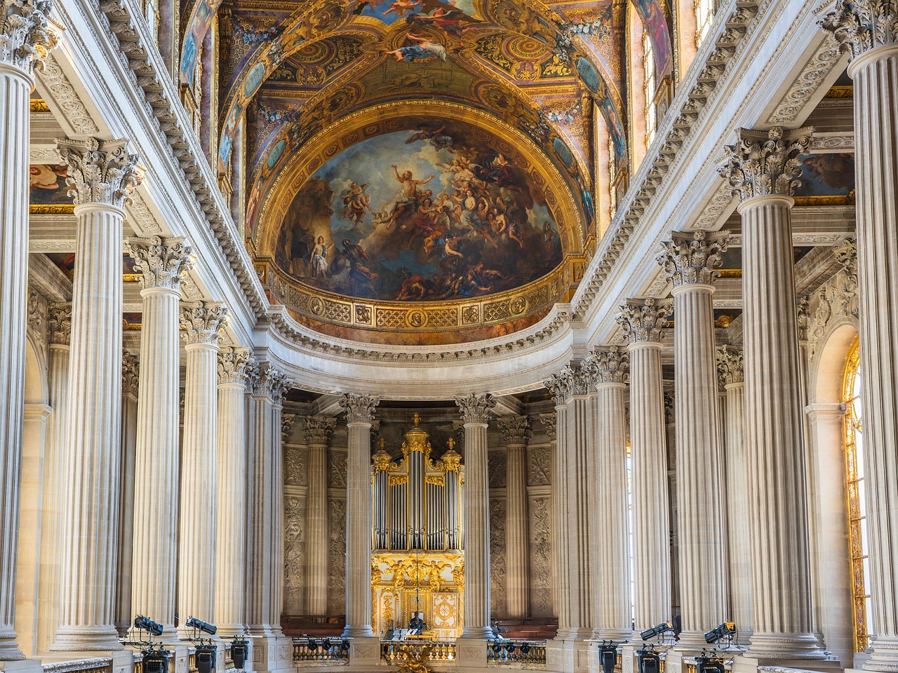 The sun-drenched Hall of Mirrors at Versailles, featuring 17 arched windows opposite 17 mirrored arches, gold leaf details, and shimmering chandeliers Sunlit Hall of Mirrors at Palace of Versailles with ornate gilding and crystal chandeliers