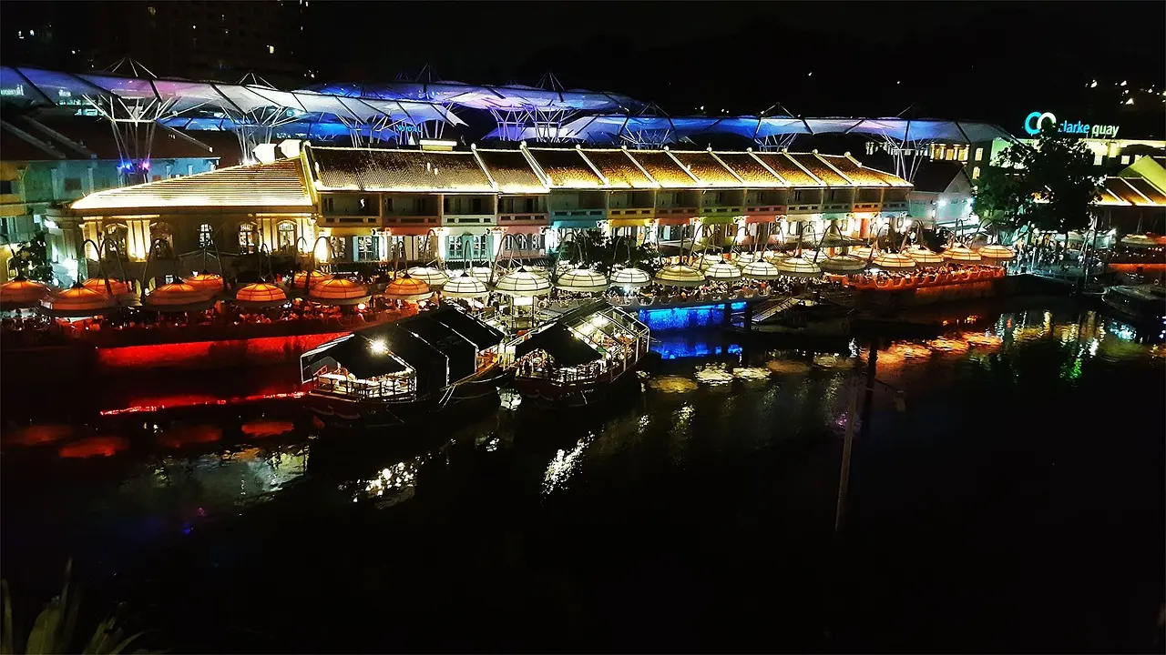 Vibrant Clarke Quay at night—neon-lit, riverside, and alive with energy—encapsulating Singapore’s dynamic blend of heritage and modernity, and affirming its spot among the top in Singapore must-visit districts. Clarke Quay at night with colorful neon signs, riverside dining, and lit-up heritage shophouses