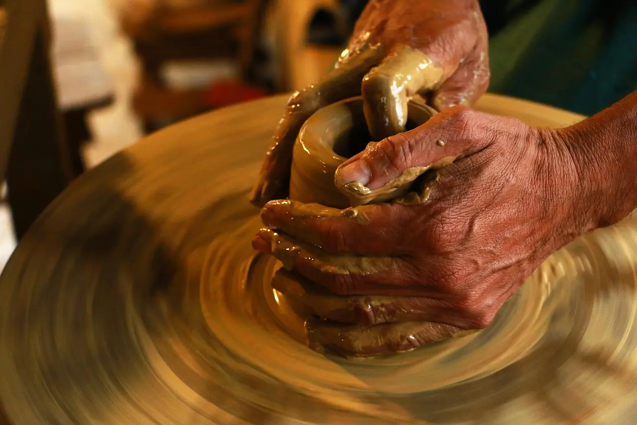 Traditional Oaxacan mole negro preparation in a hand-thrown clay pot, simmering with ancho chiles, chocolate, and toasted nuts Close-up of dark, glossy mole negro being stirred in a clay cazuela over low flame