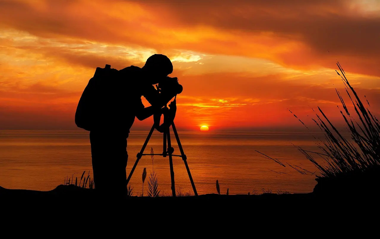 A professional photographer capturing the Eiffel Tower at sunrise — illustrating best practices for creating authentic, high-impact images across all travel destinations for landmark photography Travel photographer using DSLR on tripod at sunrise, capturing Eiffel Tower from Trocadéro plaza