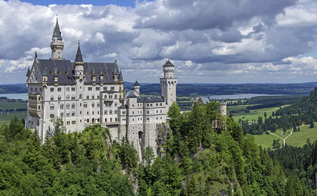 Vista panorámica del famoso castillo de Neuschwanstein en Baviera, Alemania Castillo de Neuschwanstein rodeado de montañas y árboles verdes