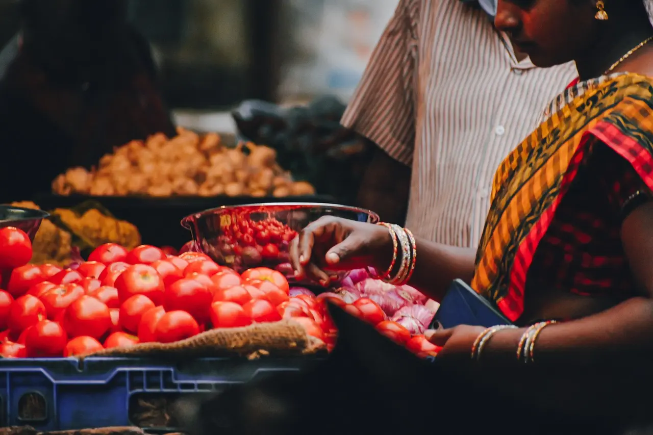 La Boqueria in Barcelona: A feast for the senses and a vibrant, culturally rooted shopping destination for travelers Vibrant fruit and seafood stalls at La Boqueria Market with mosaic floors and hanging hams