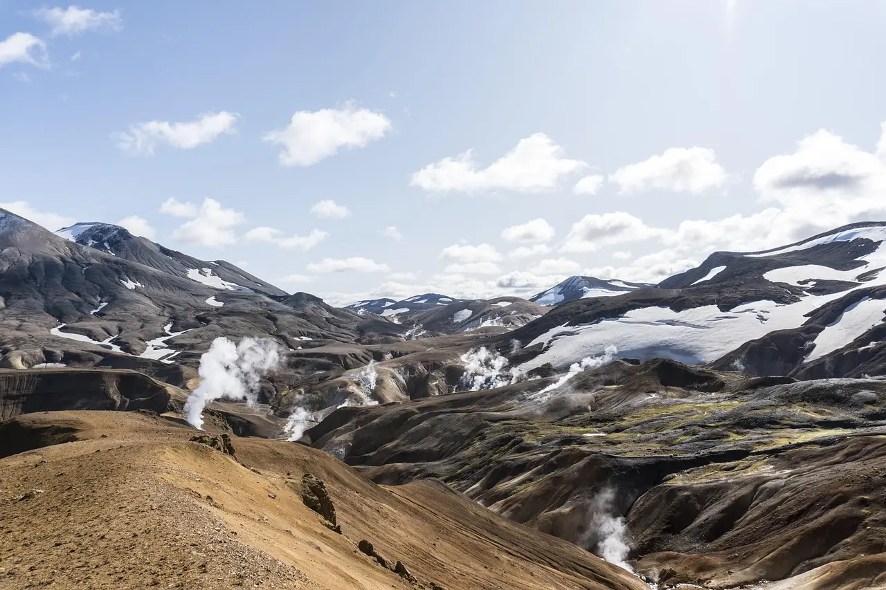 Reykjadalur Valley in Iceland — a naturally steaming, remote travel destination for relaxation surrounded by volcanic terrain Steam rising from turquoise geothermal pools nestled in moss-covered Icelandic lava fields at dusk