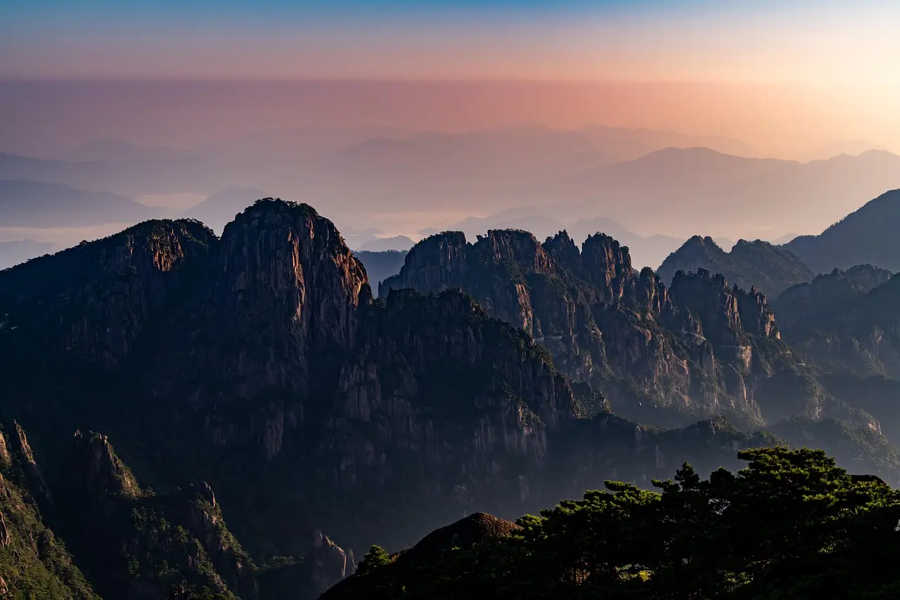 Espectacular amanecer en las Montañas Amarillas con un mar de nubes y pinos icónicos Amanecer sobre las cumbres neblinosas de Huangshan