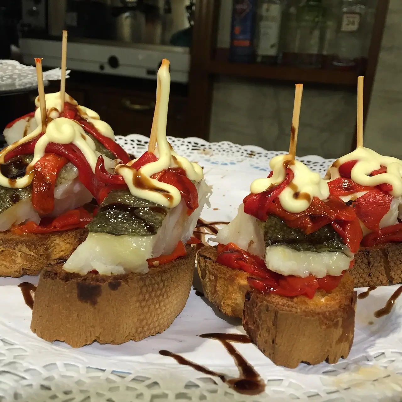 Assortment of artisanal pintxos in San Sebastián’s Old Town, featuring local anchovies, Idiazabal cheese, and wild mushroom croquettes Colorful array of pintxos on wooden board: anchovy-stuffed olives, smoked salmon, and mini croquettes