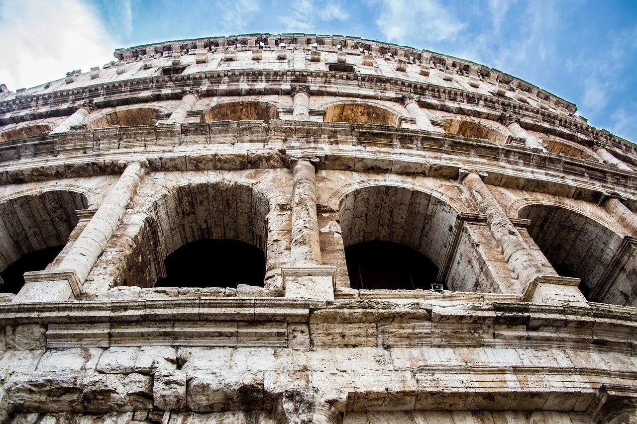 Sunlight filters through the Colosseum’s vaulted arches — an evocative interior shot that highlights the grandeur and human scale of visiting ancient landmarks in Italy. Interior view of the Colosseum’s tiered seating under soft daylight
