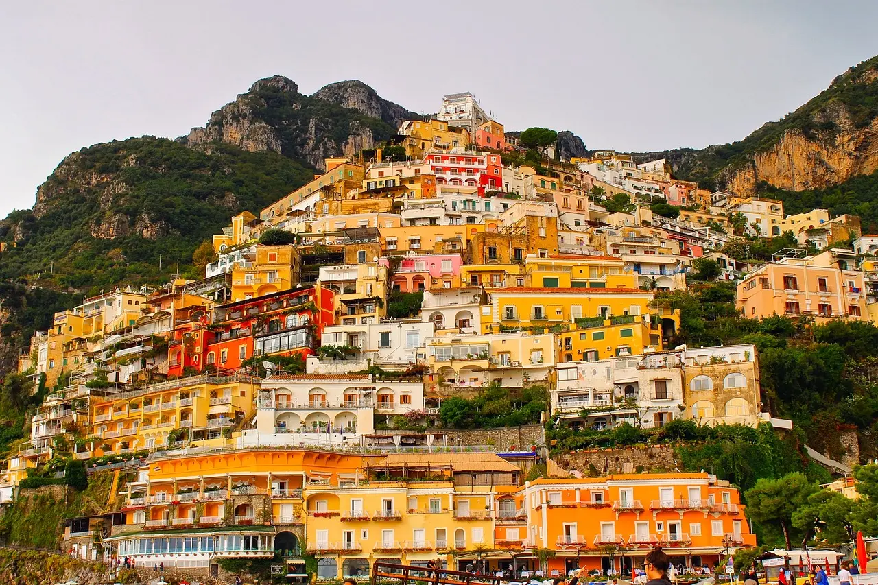 Vibrant Positano on the Amalfi Coast — a dreamy, picturesque European honeymoon destination Colorful houses of Positano stacked along steep cliffs above turquoise Mediterranean waters