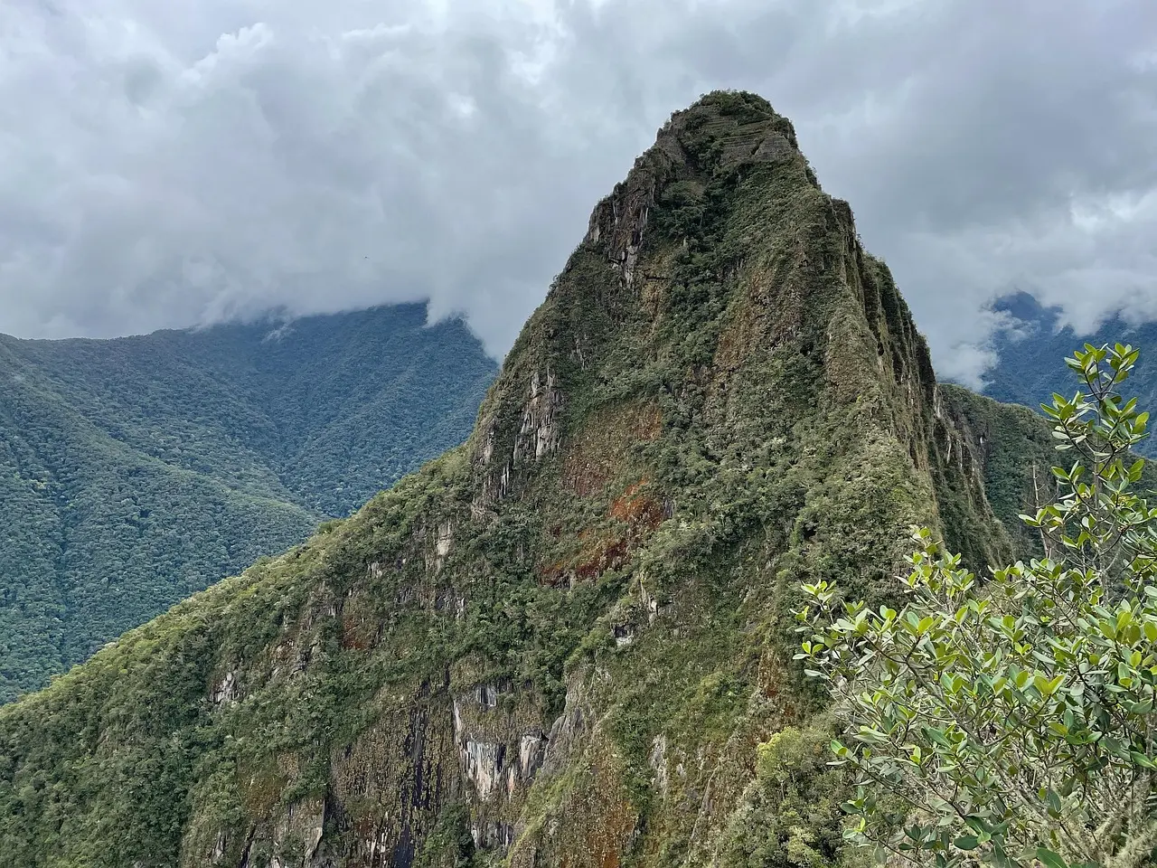 Machu Picchu emerges from morning mist — a serene, sacred setting that makes visiting ancient landmarks feel deeply personal and spiritually resonant. Machu Picchu ruins nestled between misty green Andean peaks at dawn