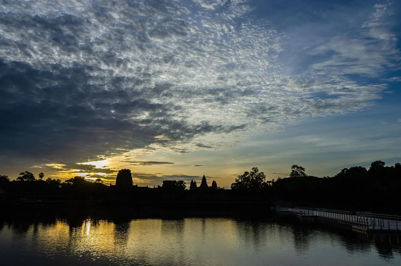 The iconic silhouette of Angkor Wat at sunrise — a serene, symbolic moment that captures the profound beauty of visiting ancient landmarks in Southeast Asia. Sunrise over Angkor Wat’s five lotus-like towers reflected in still water